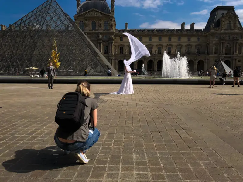 Bride's veil blowing in the wind during a bridal photo shoot - Louvre museum - Paris, France - iPhone Photography