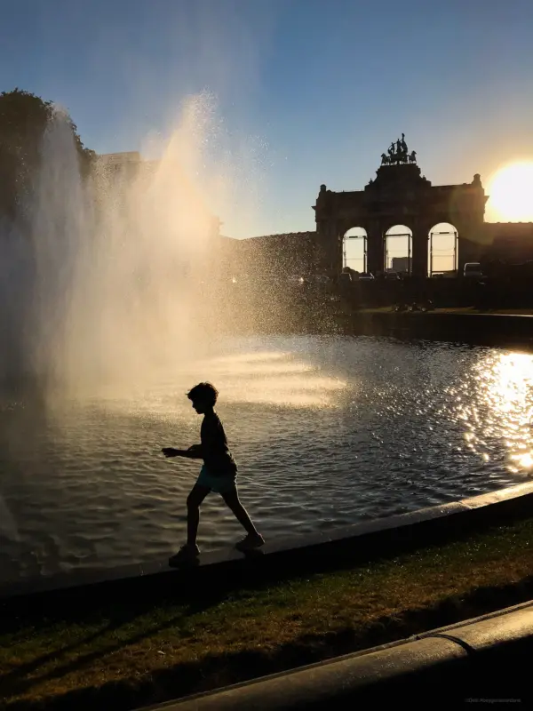 Child playing in front of a fountain - Brussels, Belgium