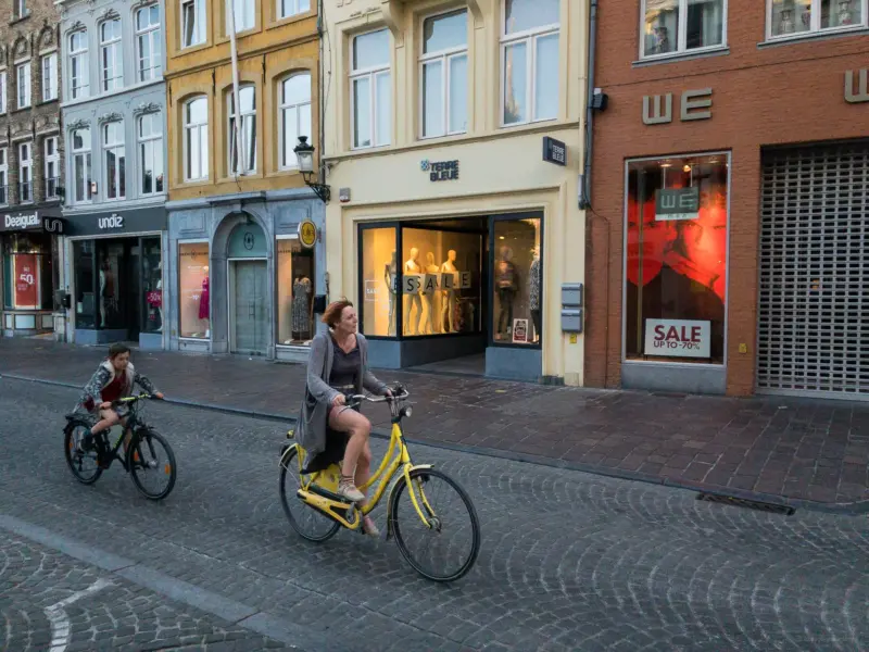 A woman and a boy riding bicycles - Bruges, Belgium
